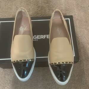 Beige and black flats with chain detail